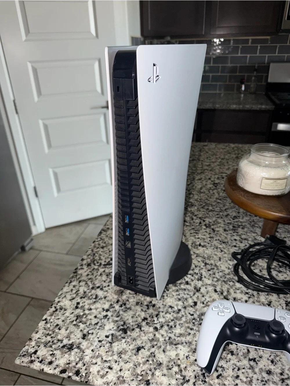 PS5 with HDMI/ power cords, controller, and stand.
